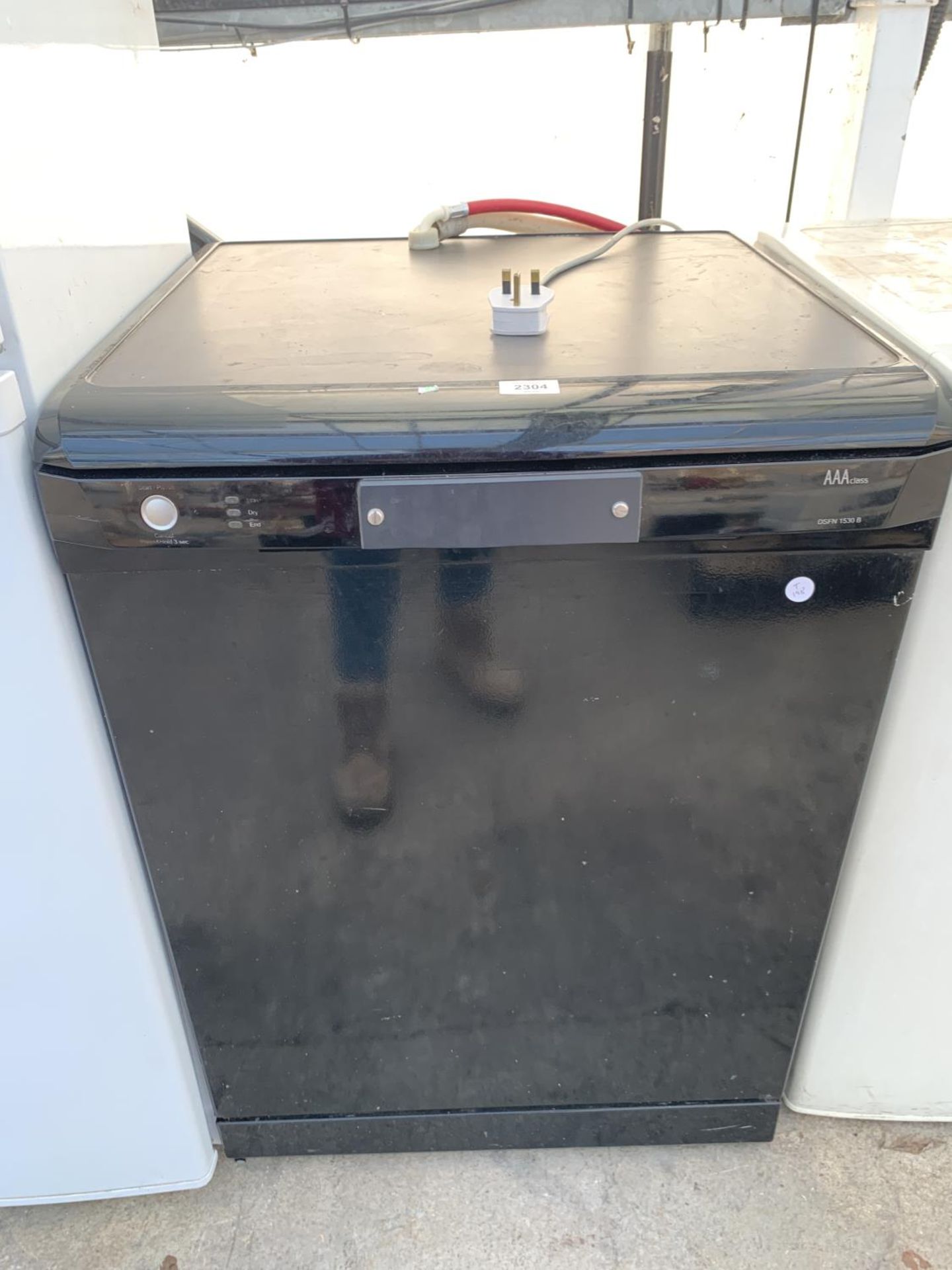 A BLACK UNDERCOUNTER DISH WASHER