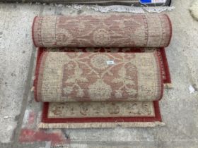 TWO SMALL RED PATTERNED FRINGED RUGS