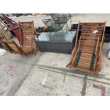 TWO FOLDING TEAK SUN LOUNGERS AND A RATTAN COFFEE TABLE