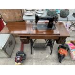 A VINTAGE SINGER SEWING MACHINE WITH OAK TABLE AND TREADLE BASE