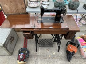 A VINTAGE SINGER SEWING MACHINE WITH OAK TABLE AND TREADLE BASE