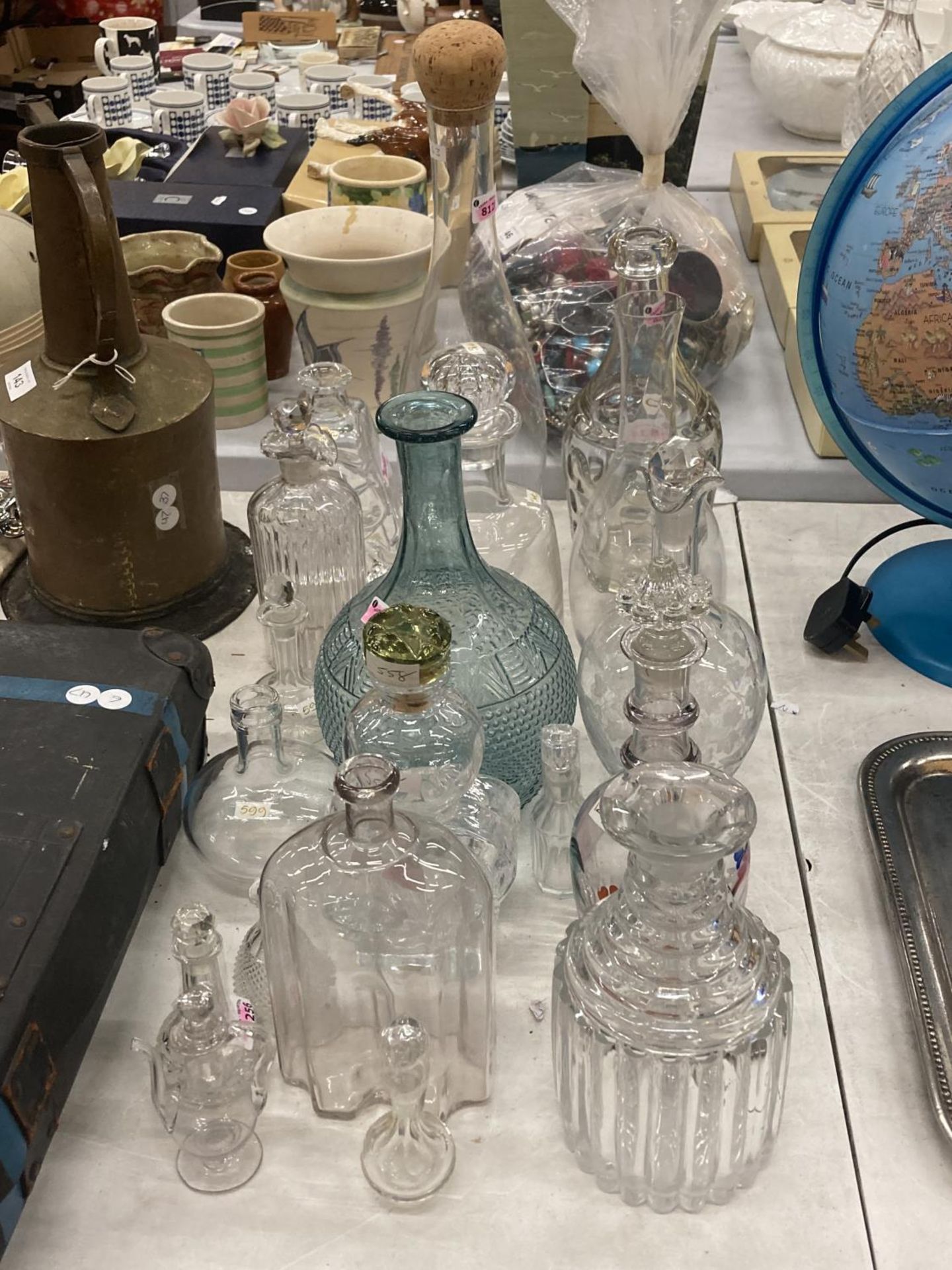 A QUANTITY OF GLASS BOTTLES SOME WITH STOPPERS AND DECANTERS