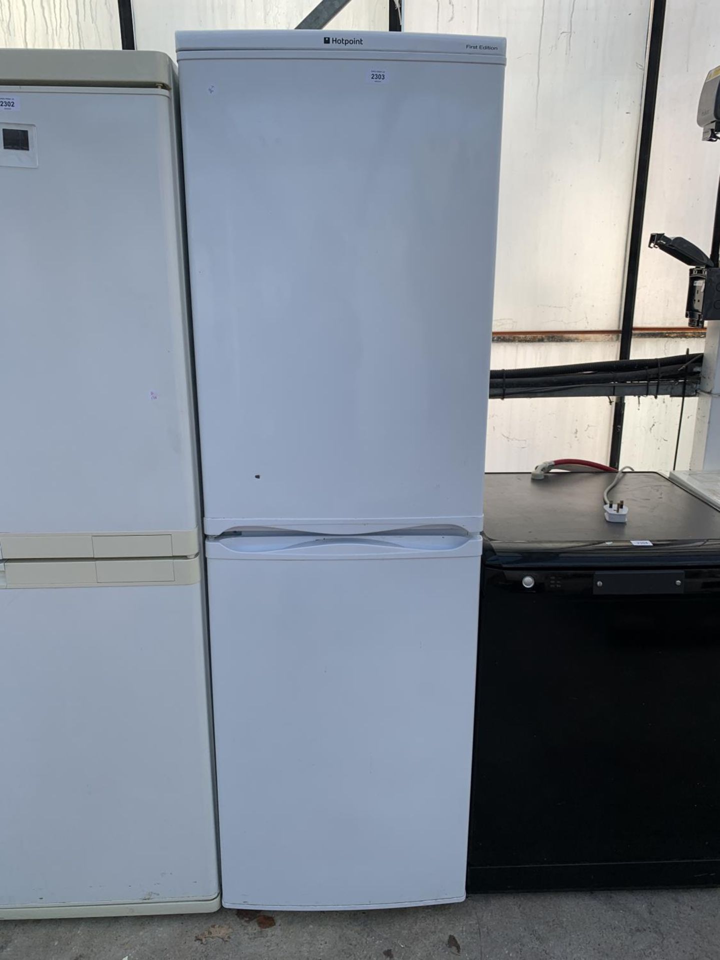 A TALL WHITE HOTPOINT UPRIGHT FRIDGE FREEZER