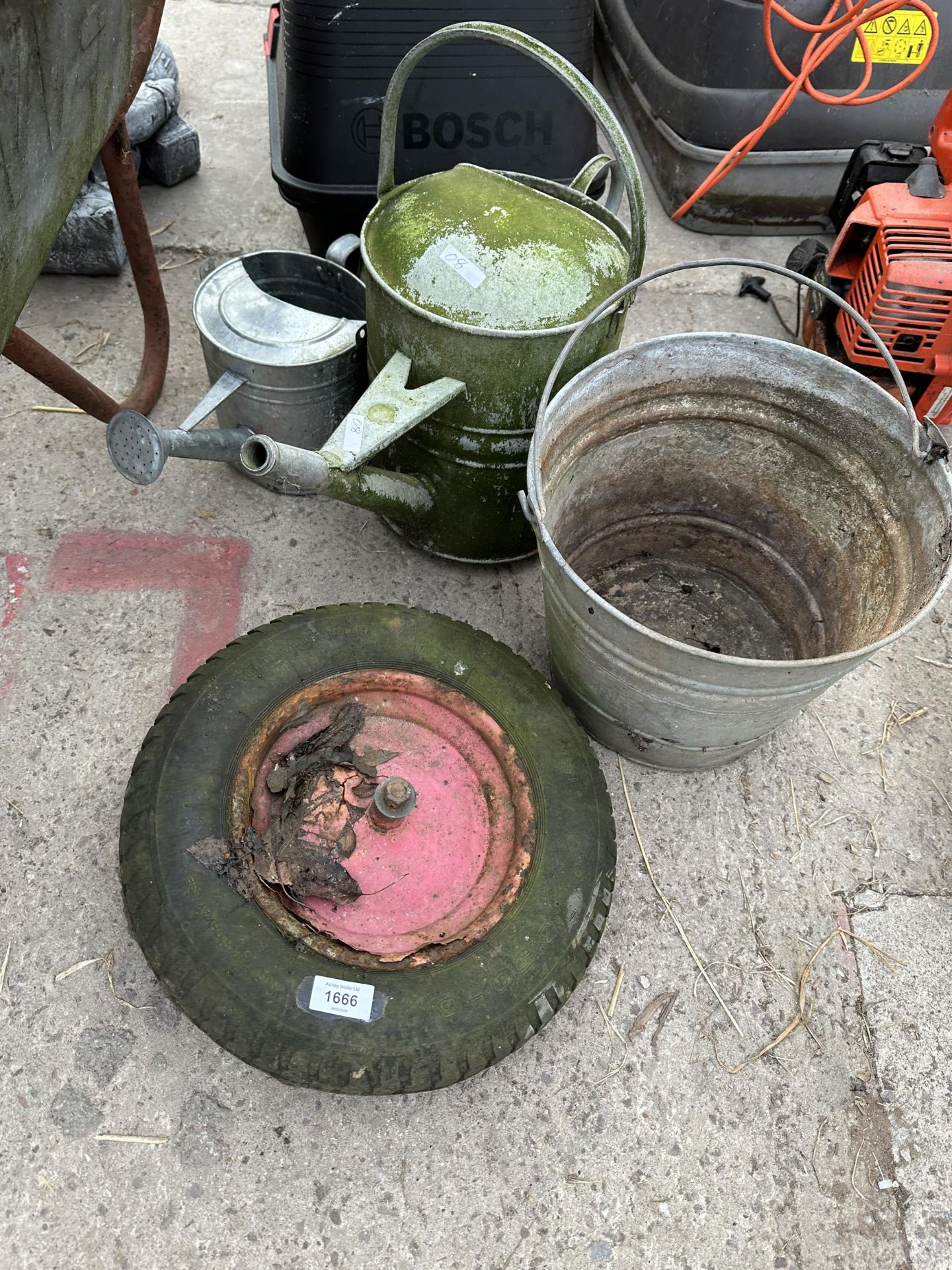 AN ASSORTMENT OF ITEMS TO INCLUDE A WHEEL BARROW WHEEL, A GALVANISED BUCKET AND WATERING CAN ETC