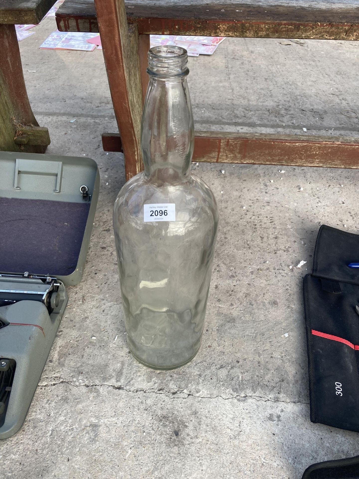 A LARGE GLASS BOTTLE