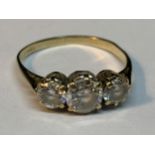 A 9 CARAT GOLD RING WITH THREE IN LINE CUBIC ZIRCONIAS SIZE J/K