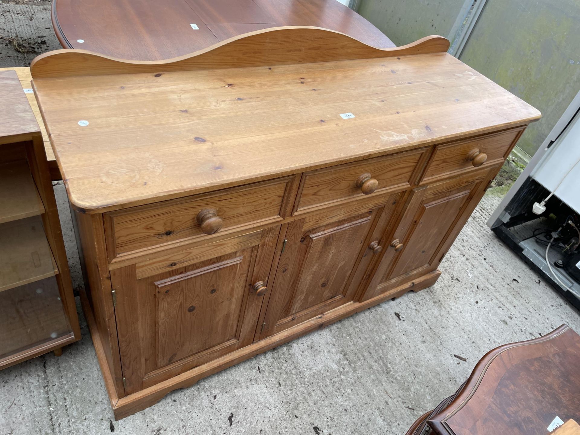 A MODERN PINE DRESSER BASE ENCLOSING DRAWERS AND CUPBOARD - 54 INCH WIDE