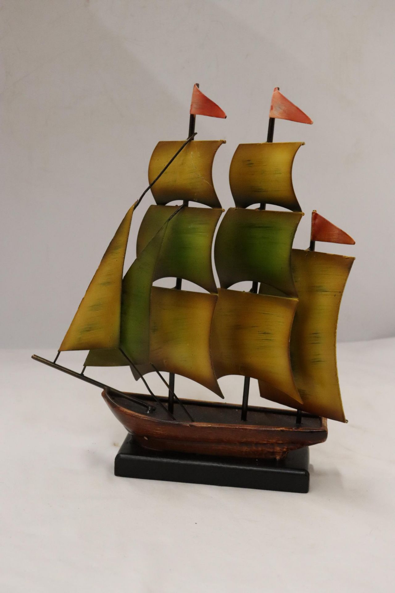 A VINTAGE ALL METAL SAILING SHIP ON METAL BASE, HEIGHT 28CM, WIDTH 23CM