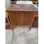 A WALNUT CABINET ON CABRIOLE LEGS