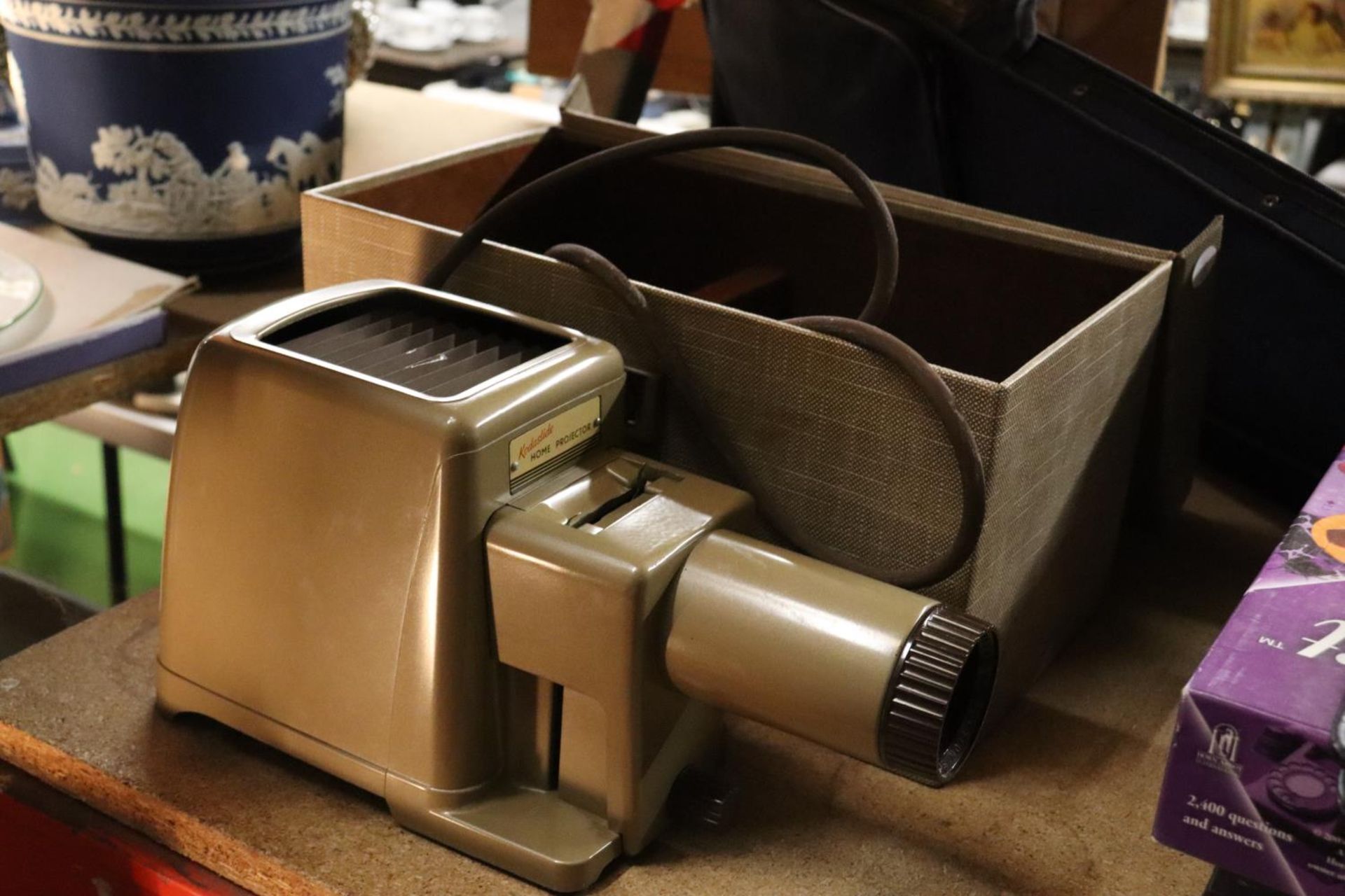 A VINTAGE KODASLIDEHOME PROJECTOR IN ORIGINAL CASE PLUS A LEATHER BRIEFCASE