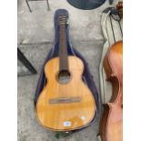 AN ACOUSTIC GUITAR WITH CARRY BAG