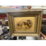 A GILT FRAMED VINTAGE PHOTOGRAPH OF THREE CHILDREN