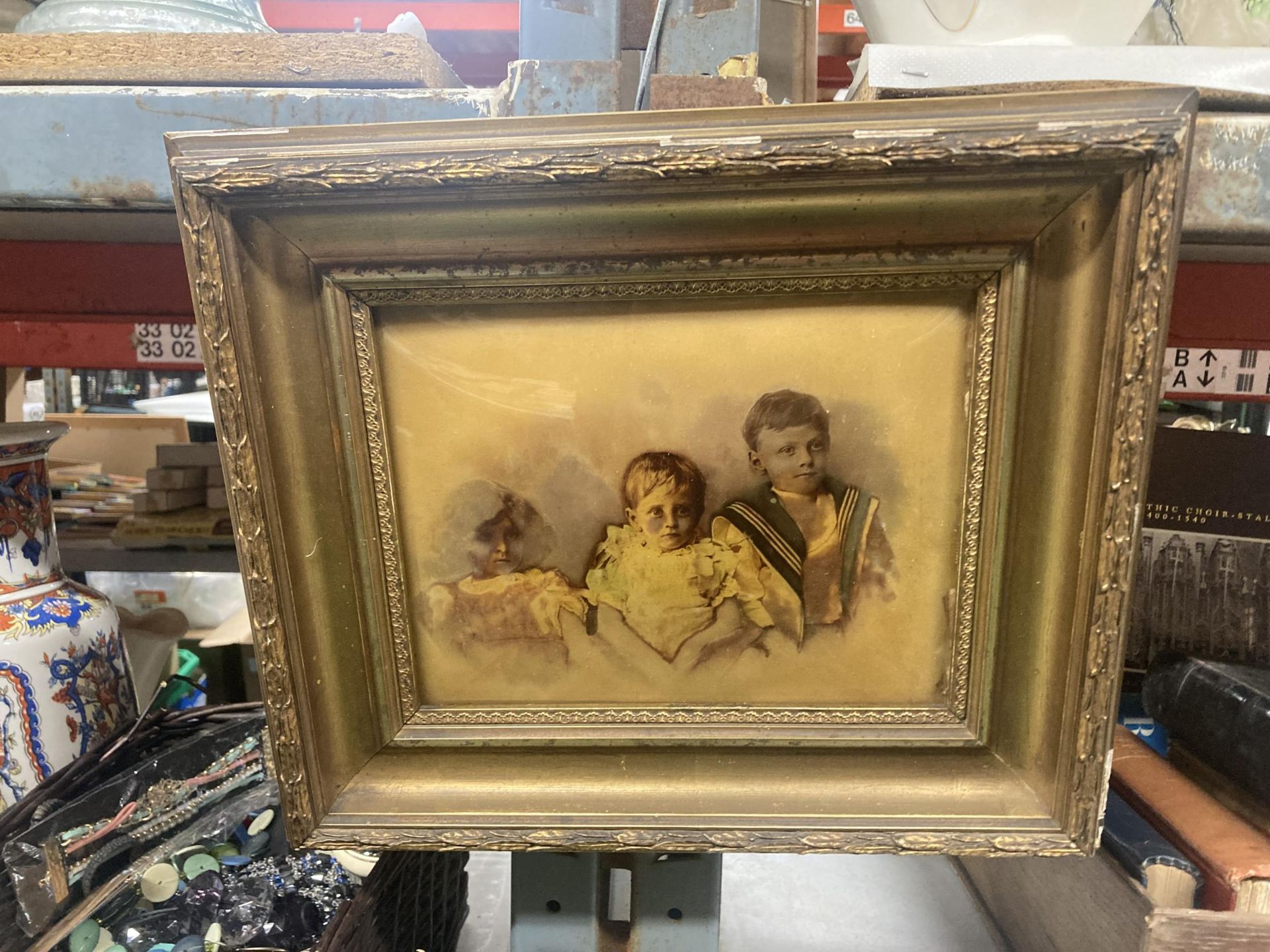 A GILT FRAMED VINTAGE PHOTOGRAPH OF THREE CHILDREN
