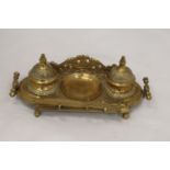 AN ORNATE BRASS INKWELL AND LETTER OPENER