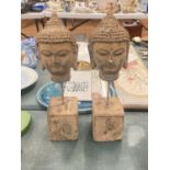 A PAIR OF STONE BUDDAHS HEADS ON PLINTHS, HEIGHT 30CM