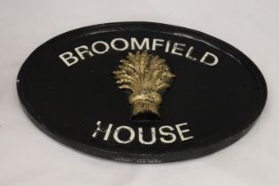 A CAST IRON HOUSE SIGN, 39CM X 28CM