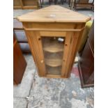 A GLAZED PINE CORNER CUPBOARD - 23" WIDE