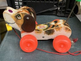 A 1965 FISHER PRICE 'LITTLE SNOOPY' PULL ALONG WOODEN DOG