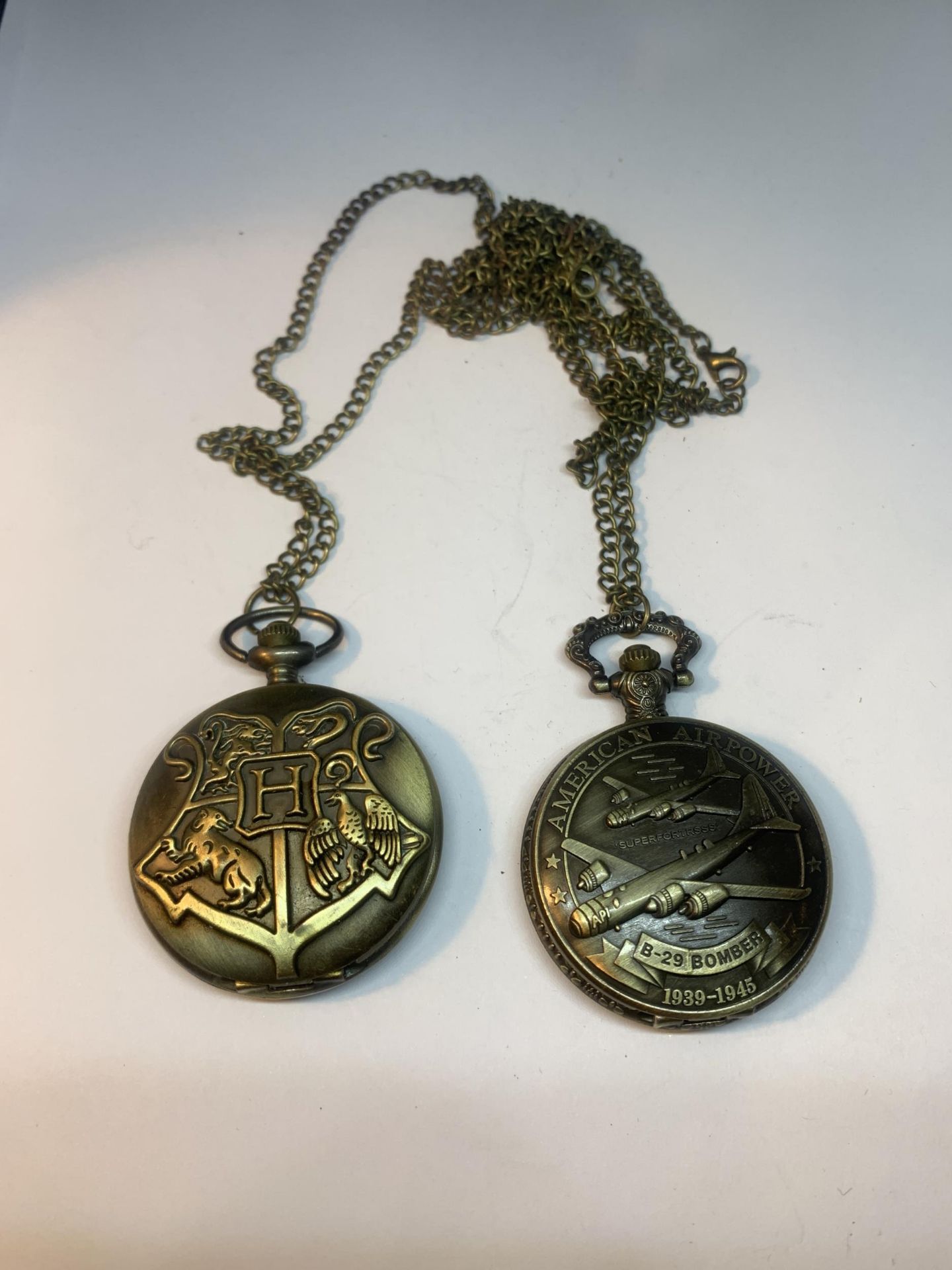 TWO POCKET WATCHES WITH IMAGES OF USA BOMBER AND A COAT OF ARMS