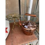 A LARGE VINTAGE COPPER KETTLE AND A BRASS TRIVET STAND