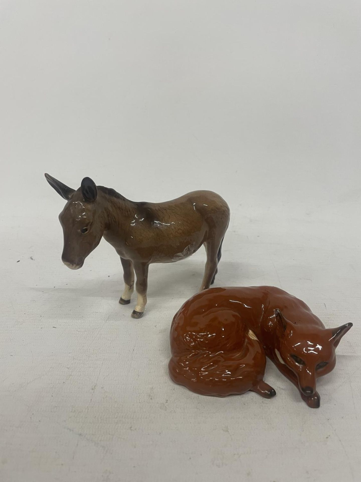 TWO BESWICK FIGURES TO INCLUDE A DONKEY AND A FOX