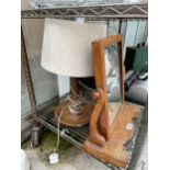 AN OAK SWING FRAME DRESSING TABLE MIRROR AND A DECORATIVE OAK TABLE LAMP