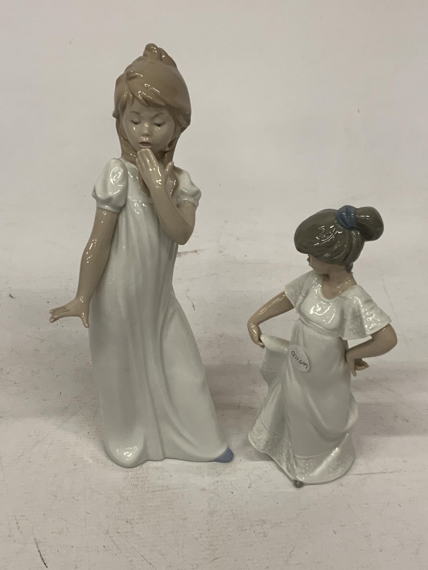 TWO NAO FIGURES TO INCLUDE A YAWNING AND A DANCING GIRL
