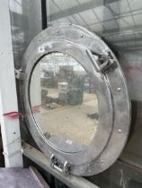 A LARGE CAST ALLOY PORTHOLE STYLE MIRROR