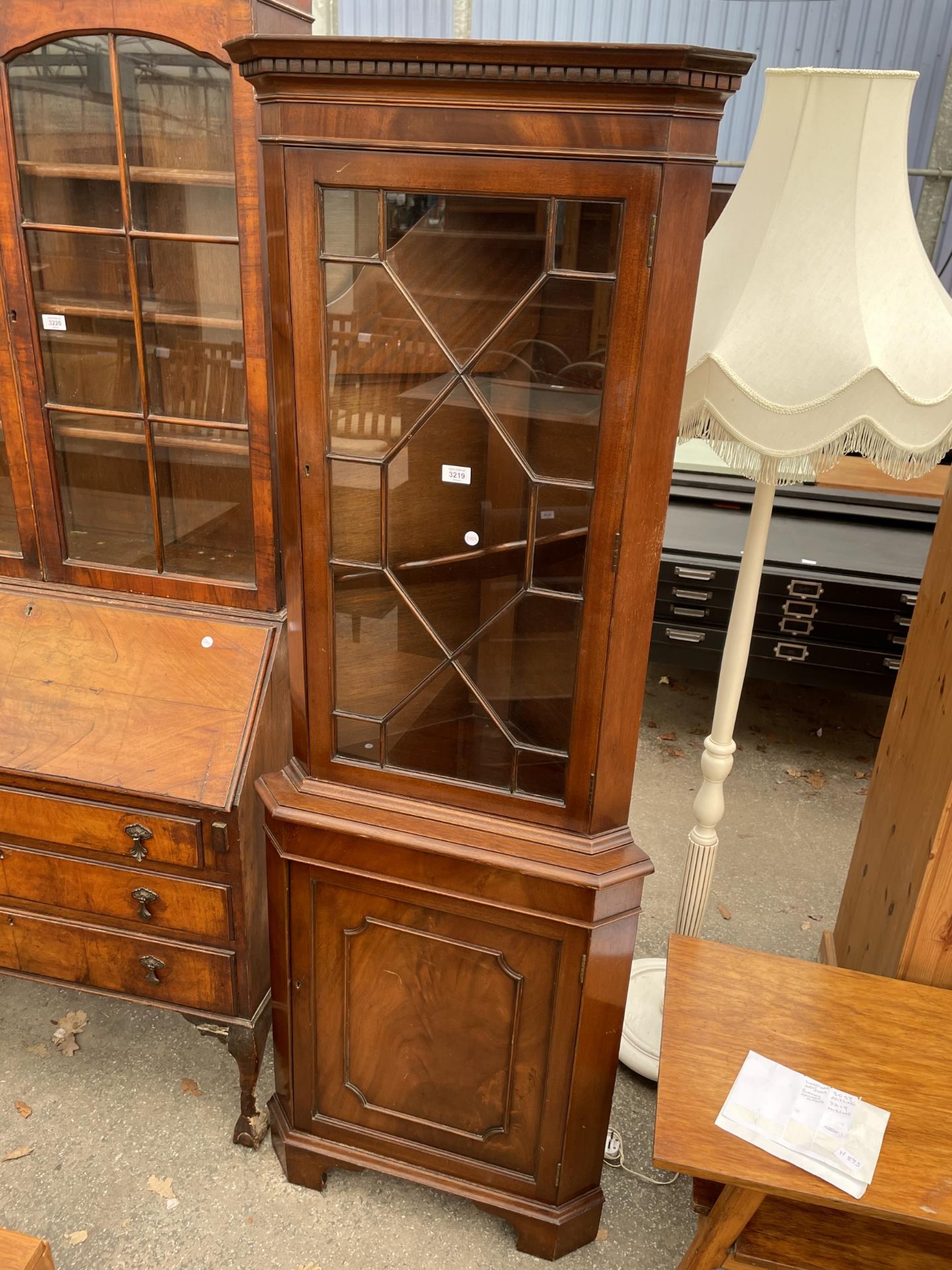 A BURTON REPRODUCTIONS MAHOGANY CORNER CUPBOARD WITH GLAZED UPPER PORTION AND DENTIL CORNICE