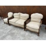 AN EDWARDIAN WALNUT BERGERE THREE PIECE LOUNGE SUITE ON CABRIOLE LEGS AND WEBBED FEET