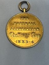 AN 1883/4 F.A. CUP FINAL WINNER'S MEDAL. THIS MEDAL IS TESTED TO 22 CARAT GOLD AND WAS AWARDED TO