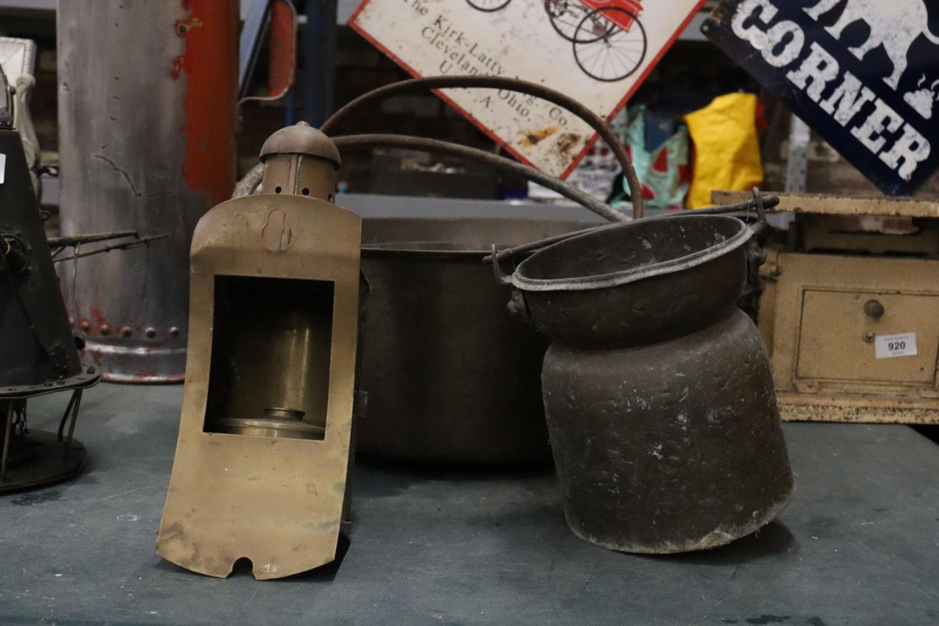 TWO LARGE HEAVY CAST PANS, A VINTAGE BRASS LAMP - A/F AND A SMALL CHURN