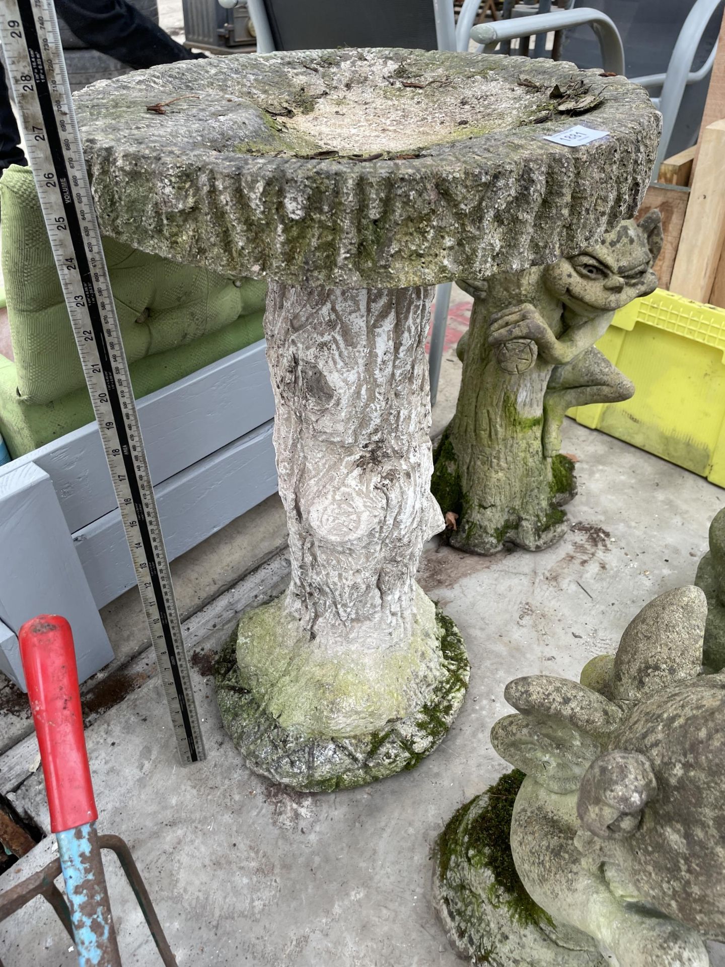 A CONCRETE GARDEN BIRDBATH WITH PEDESTAL BASE