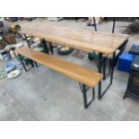 A FOLDING WOODEN TABLE AND TWO BENCHES