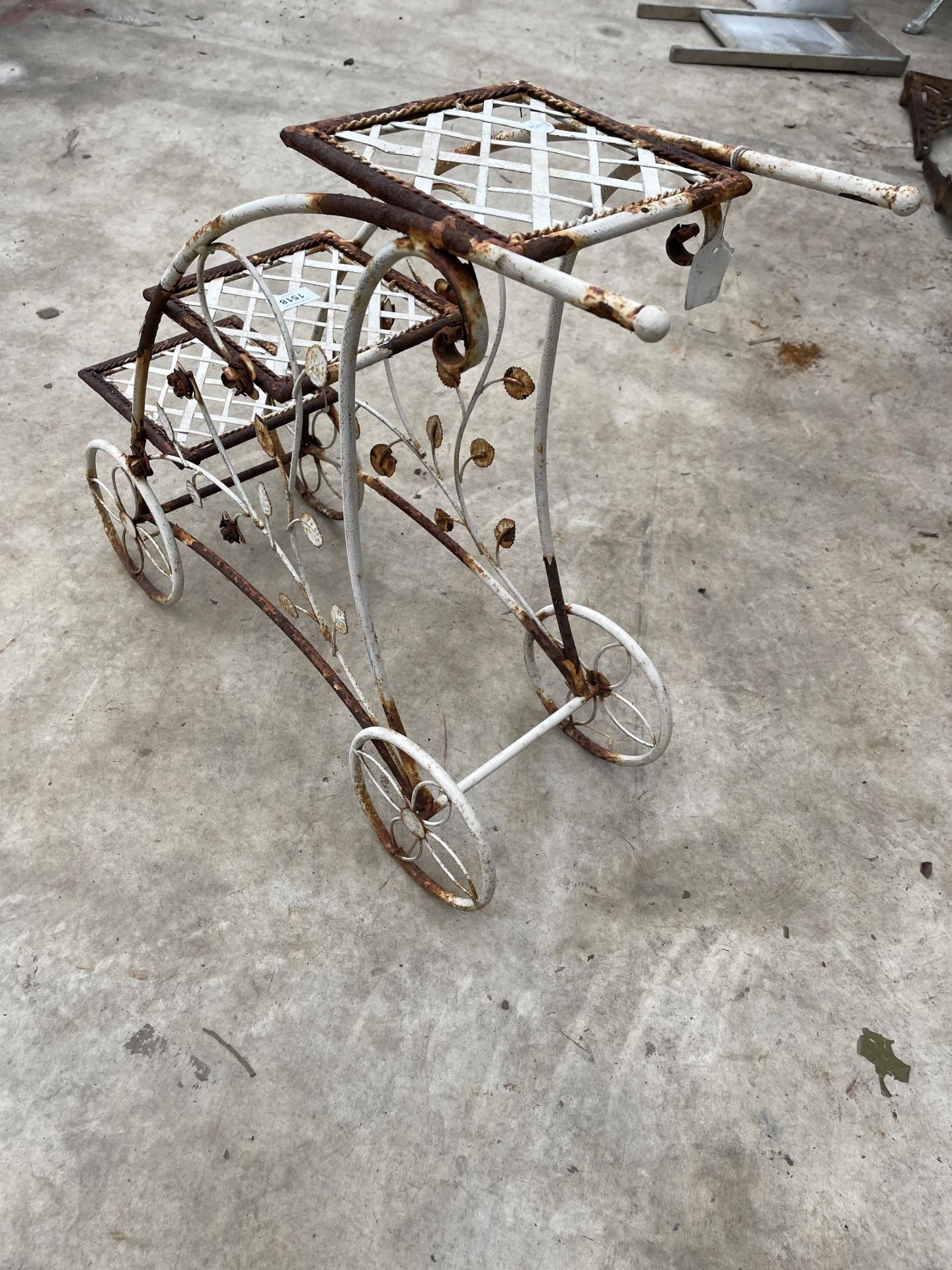 A DECORATIVE METAL THREE TIER PLANT STAND IN THE FORM OF A TROLLEY - Image 2 of 5