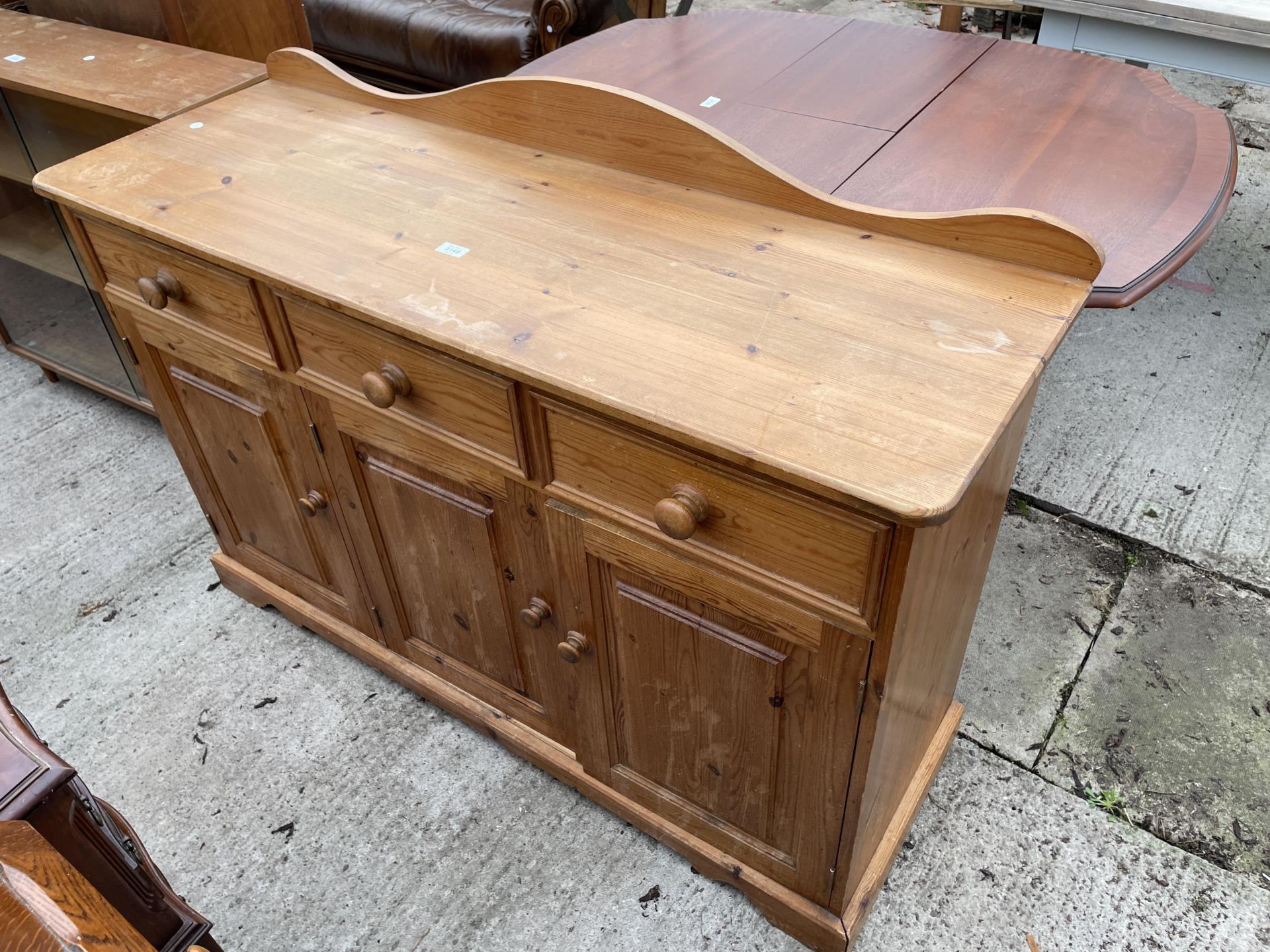 A MODERN PINE DRESSER BASE ENCLOSING DRAWERS AND CUPBOARD - 54 INCH WIDE - Image 2 of 3