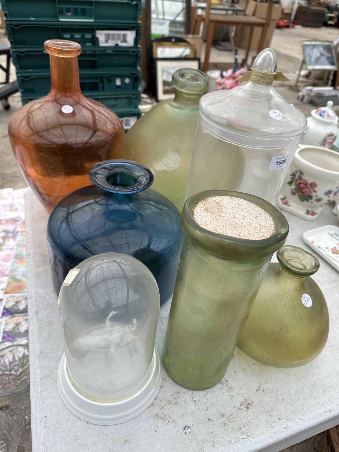 AN ASSORTMENT OF COLOURED GLASS WARE TO INCLUDE VASES AND STORAGE CADDIES ETC