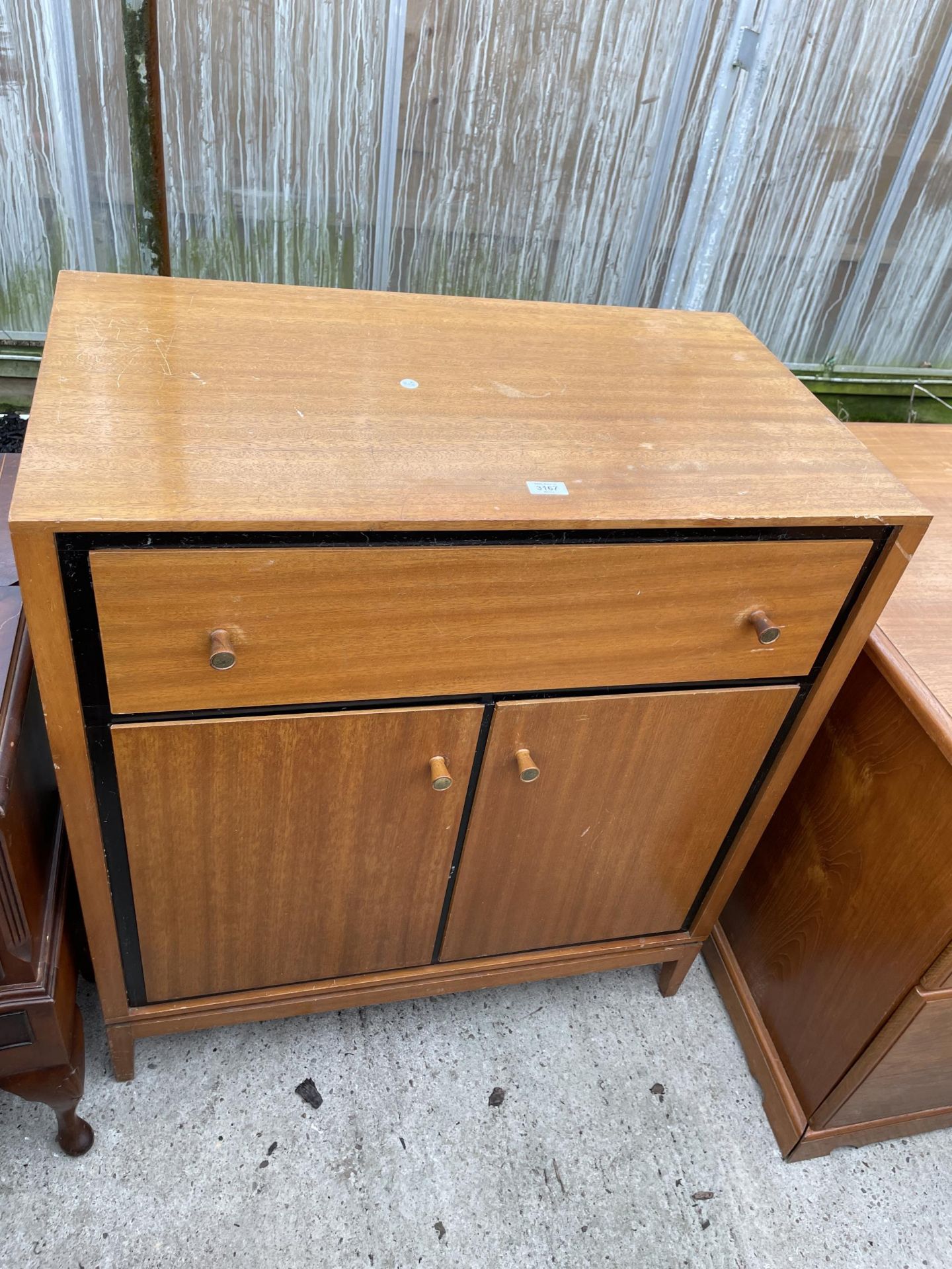 A RETRO TEAK TALLBOY ENCLOSING TWO CUPBOARDS, AND ONE DRAWER 35" WIDE