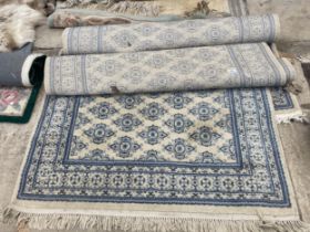 TWO MODERN CREAM AND BLUE PATTERNED FRINGED RUGS