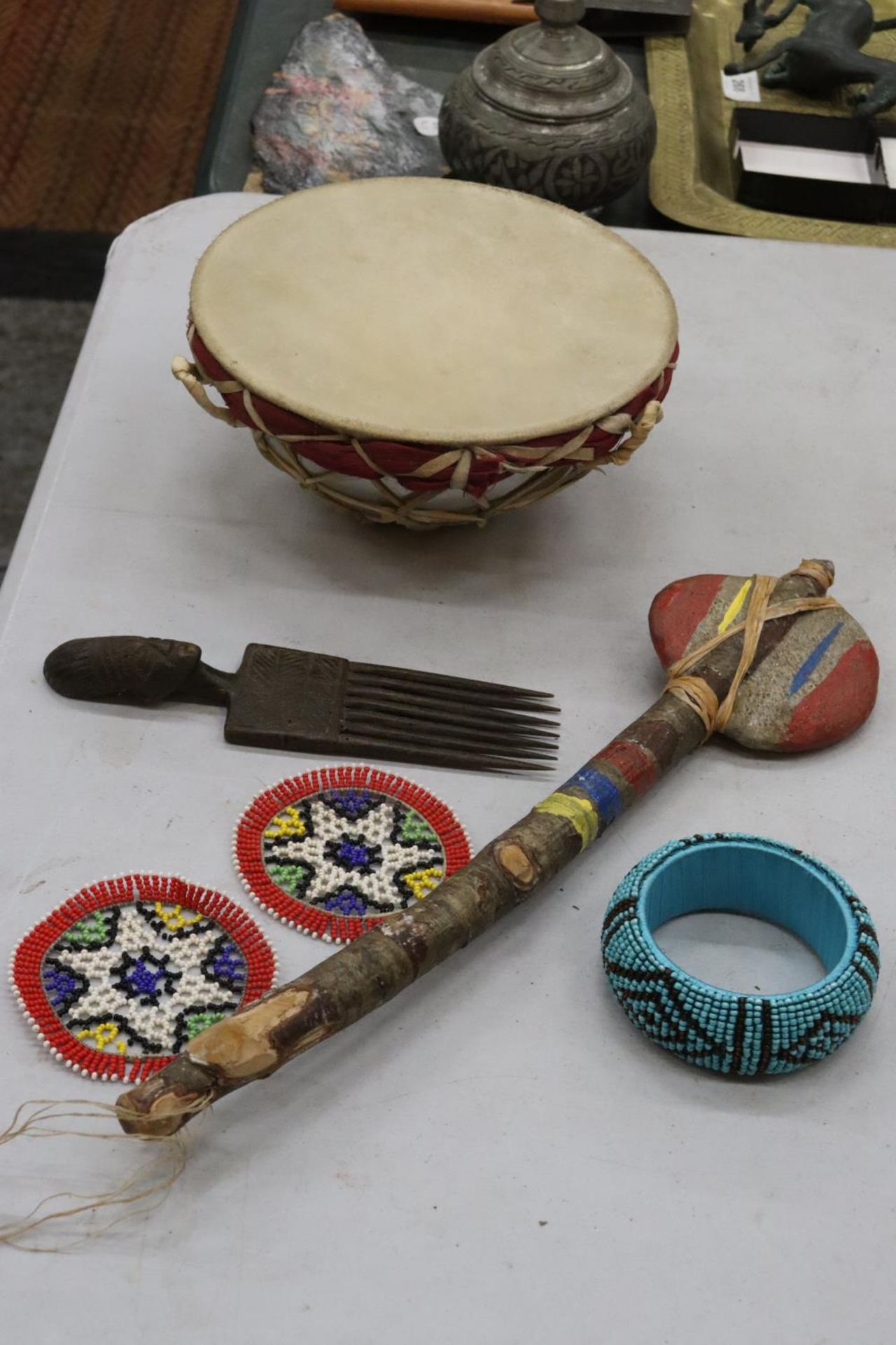 A QUANTITY OF AFRICAN ITEMS TO INCLUDE A DRUM, COMB, ETC.,