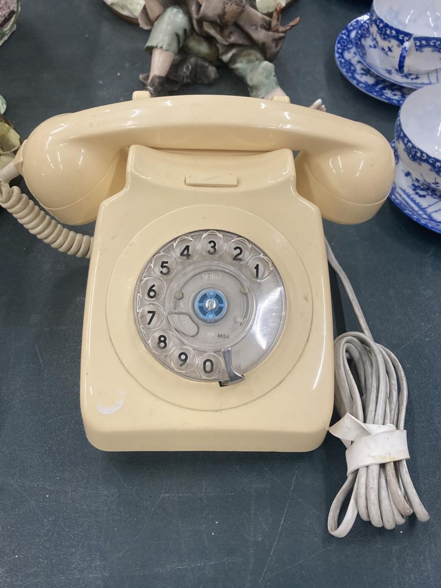 A VINTAGE CREAM ROTARY DIAL TELEPHONE