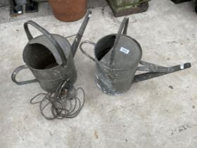 TWO GALVANISED WATERING CANS AND AN OIL CAN