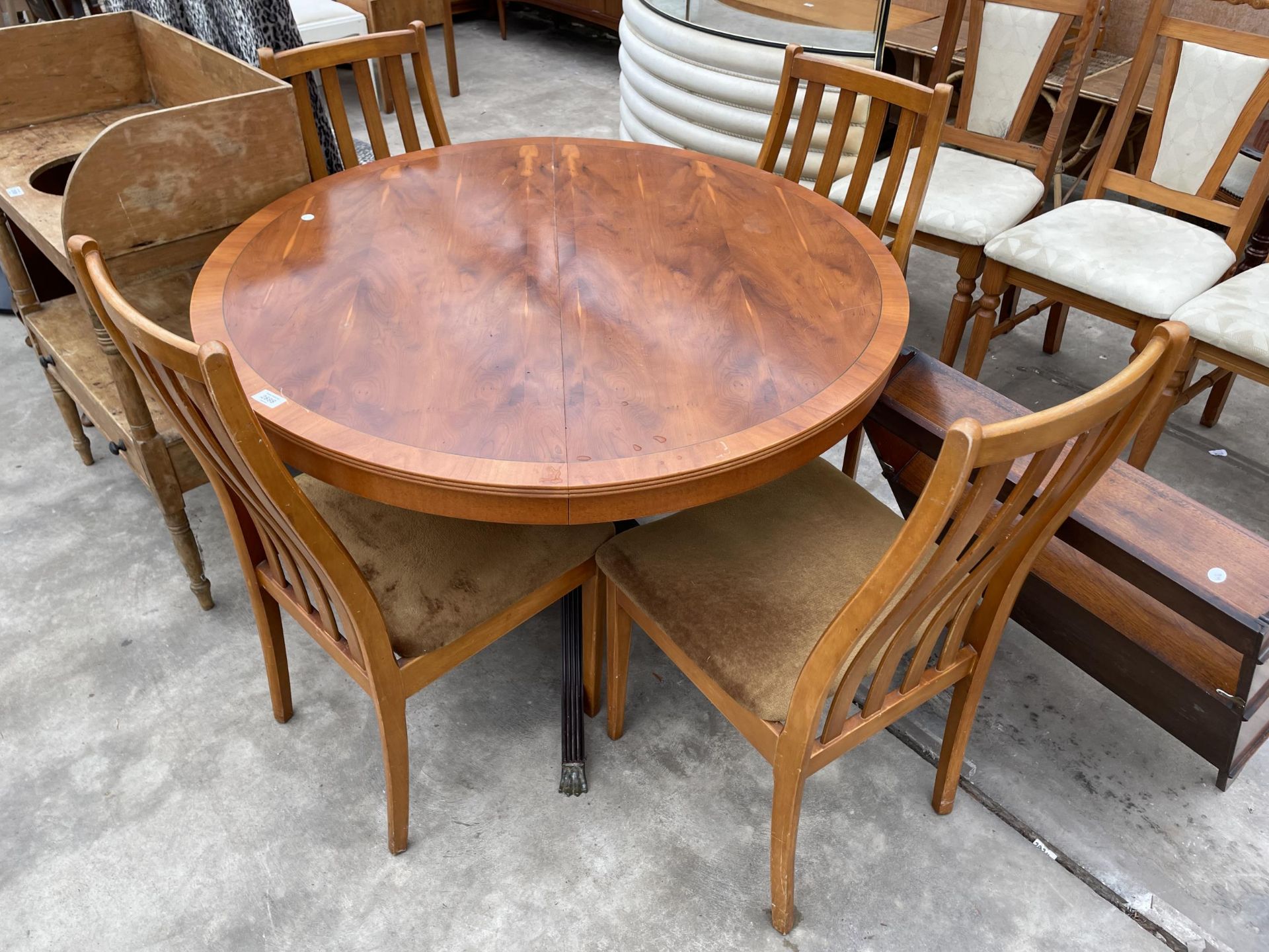 A YEW WOOD PEDESTAL DINING TABLE AND FOUR CHAIRS