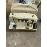 A FLEETWOOD ELECTRIC SEWING MACHINE WITH CARRY CASE