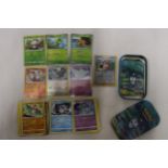 A POKEMON COLLECTORS TIN FULL OF CARDS TO INCLUDE, SHINIES, HOLOS, ETC
