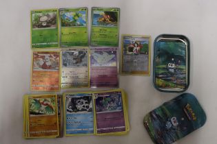 A POKEMON COLLECTORS TIN FULL OF CARDS TO INCLUDE, SHINIES, HOLOS, ETC