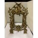 A DECORATIVE HEAVY BRASS FRAME WITH CHERUBS