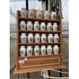 A WOODEN SPICE RACK WITH LOWER DRAWERS AND 23 GLORIA CONCEPTS THE FRANKLIN MINT LIDDED SPICE JARS
