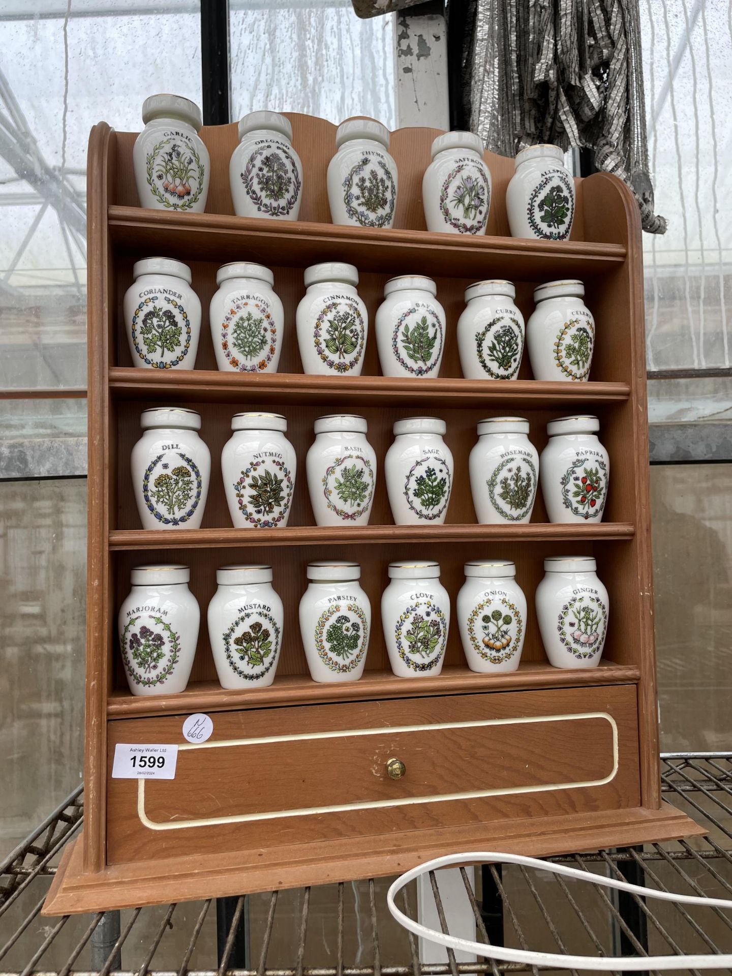 A WOODEN SPICE RACK WITH LOWER DRAWERS AND 23 GLORIA CONCEPTS THE FRANKLIN MINT LIDDED SPICE JARS