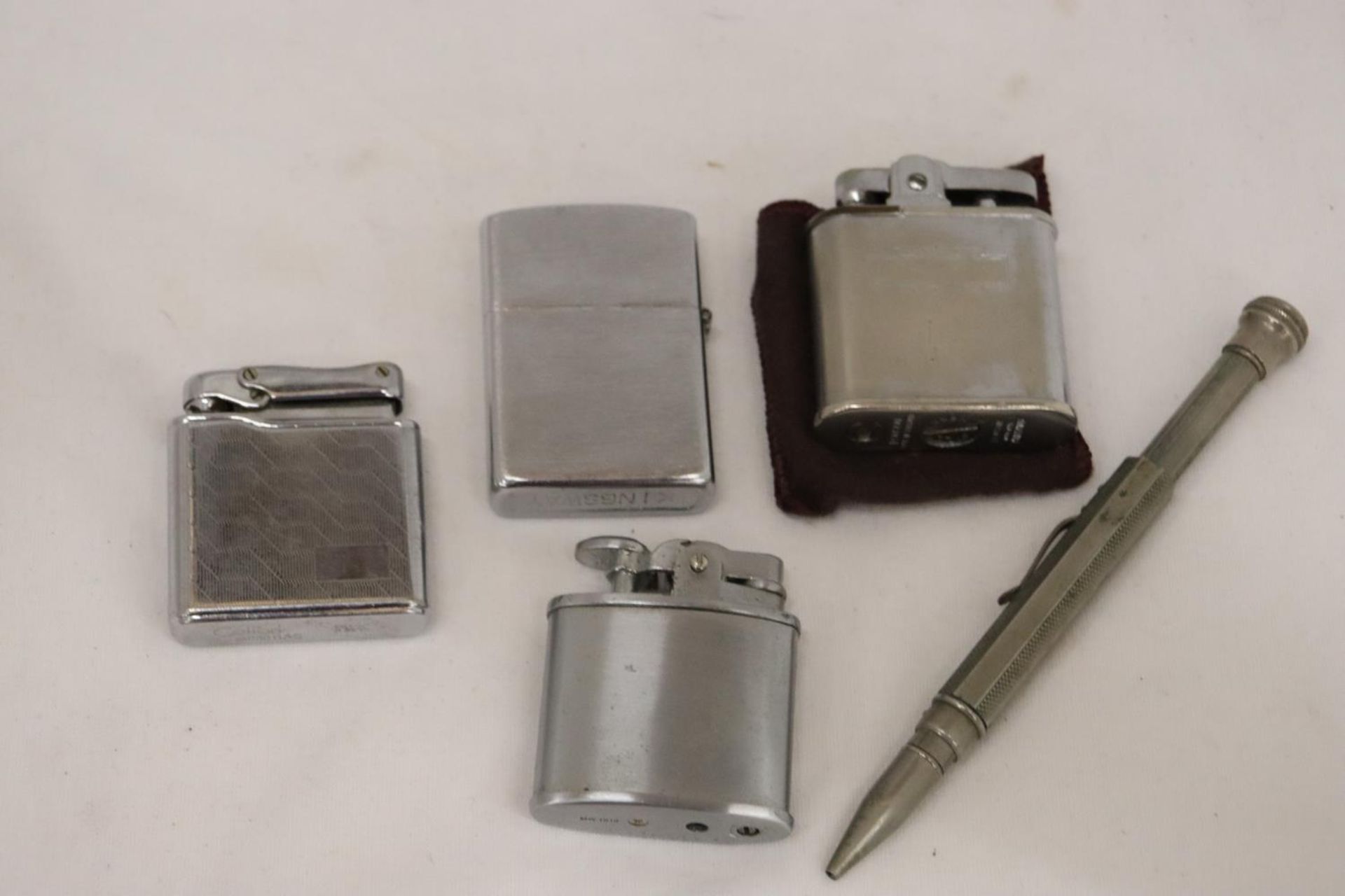 FOUR VINTAGE LIGHTERS TOGETHER WITH A PROPELLING PENCIL